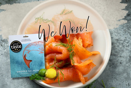 Award-winning smoked salmon on plate with herbs, lemon, and Great Taste 2025 badge visible