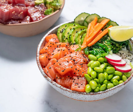 Fresh salmon sushi bowl with edamame, avocado, cucumber, carrot, radish, seaweed and rice