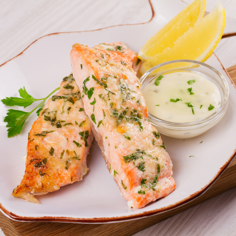 Lightly steamed trout fillets with fresh herbs and a side of mint-dill sauce and lemon.