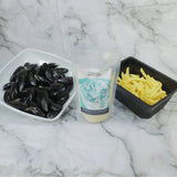 Fresh mussels in a bowl, fries, and marinière sauce kit on marble background