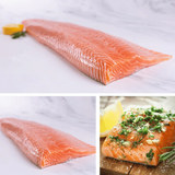 Fresh raw salmon fillet and seasoned salmon portions on white and wooden surfaces
